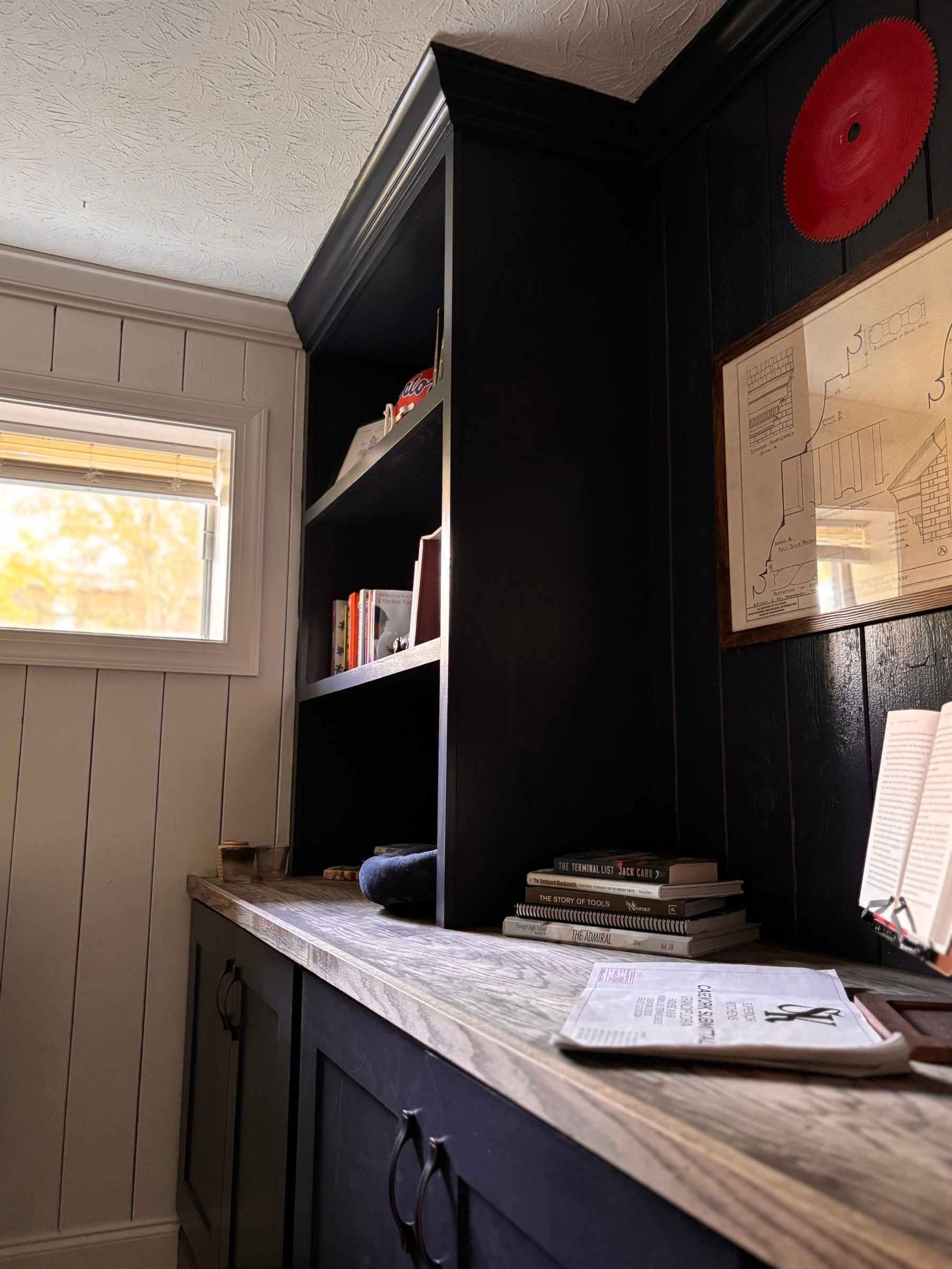 Black built-in shelving with wood accents