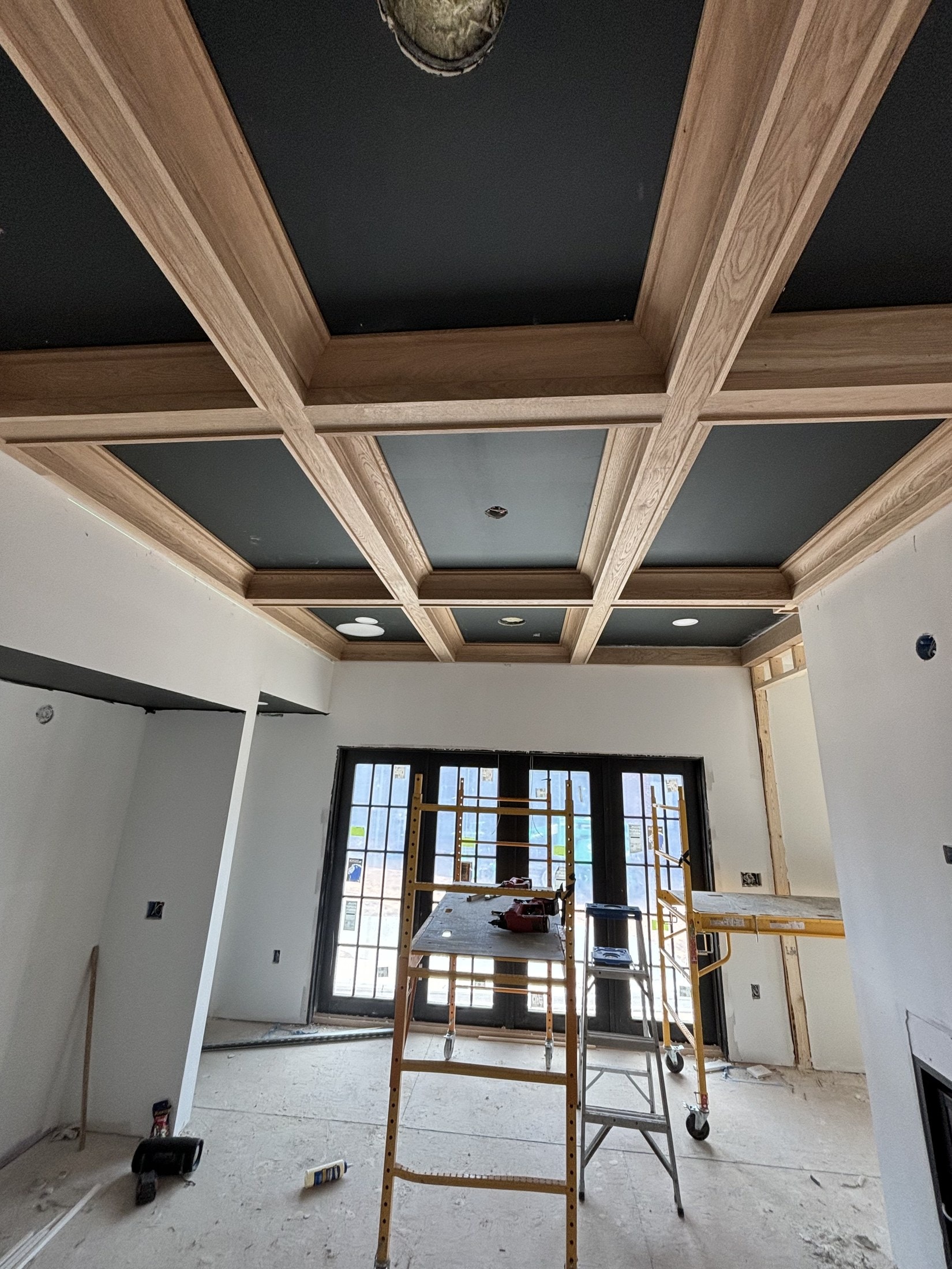 Black-painted built-ins under construction on a job site