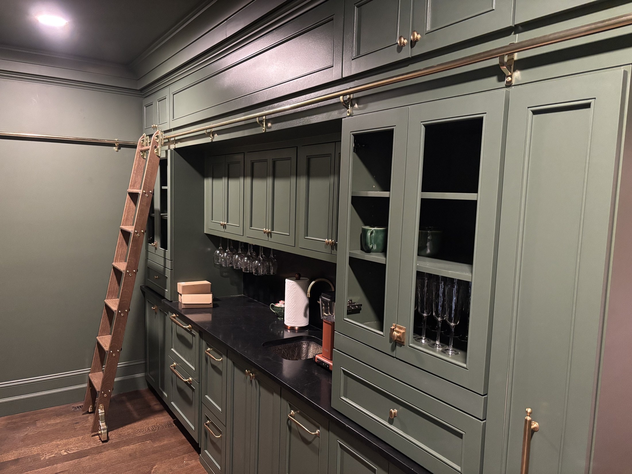 Sage-green butler's pantry cabinetry with open shelving