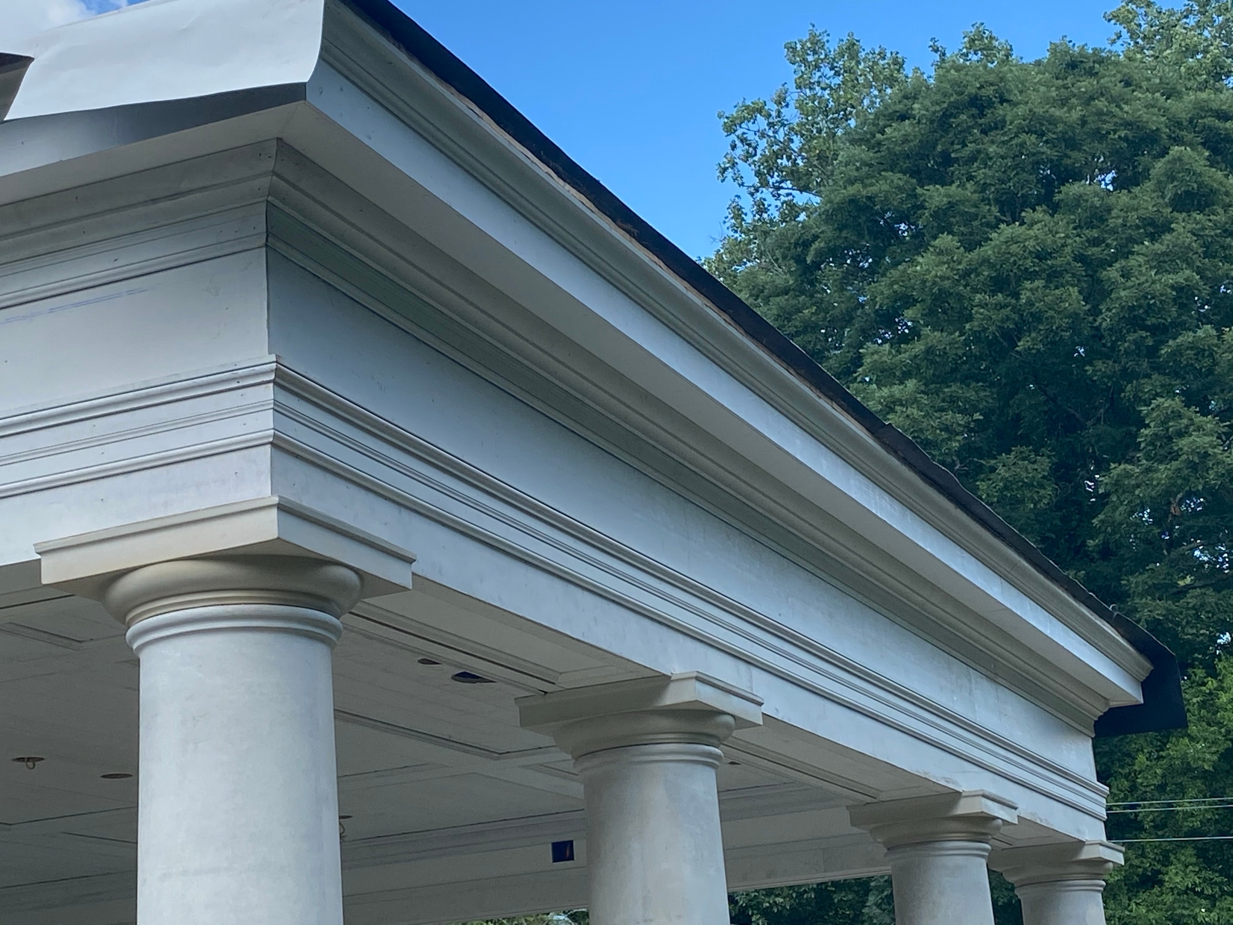 Classical portico with columns and a built-up cornice on a custom home