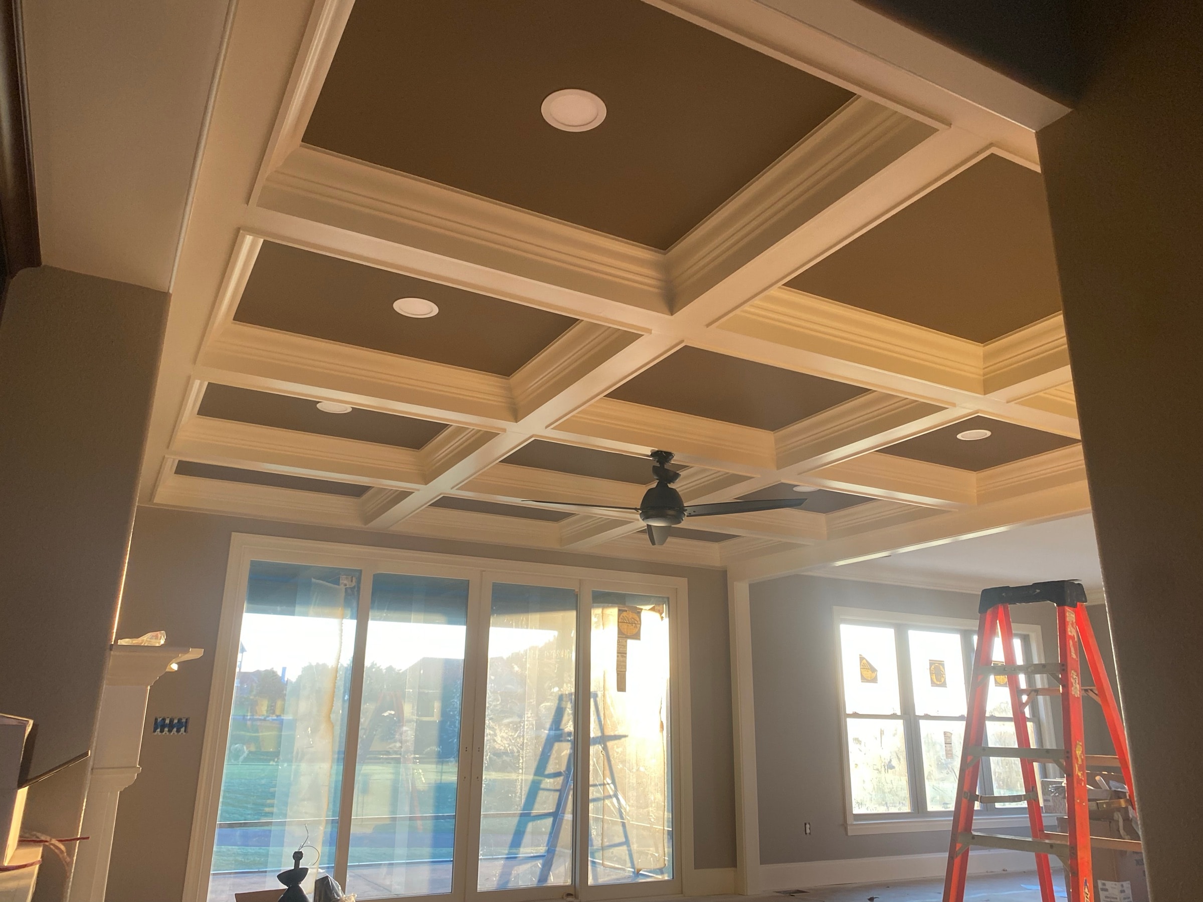 Coffered ceiling over a room with a wall of windows
