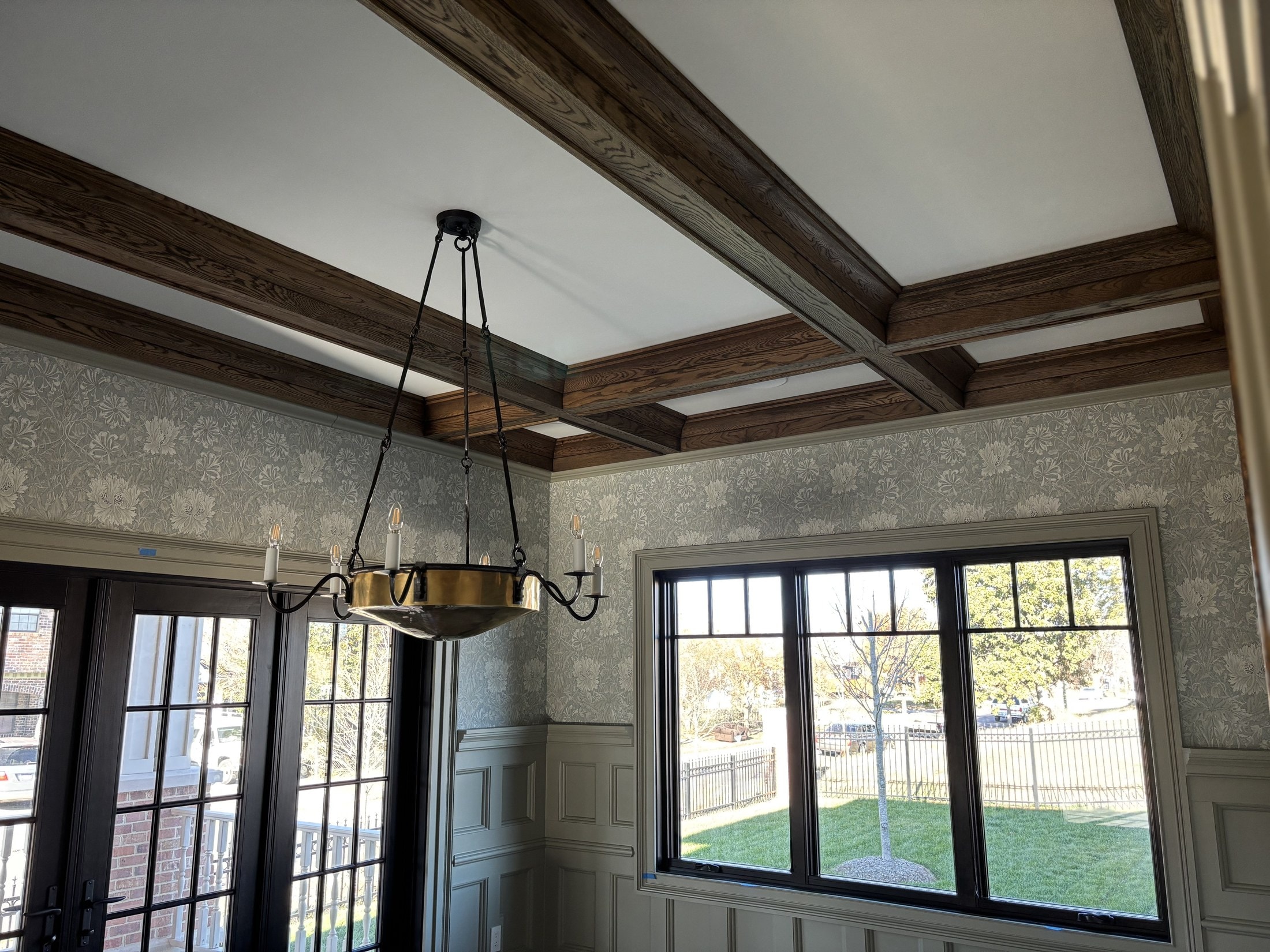 Stained box beams across a dining room ceiling