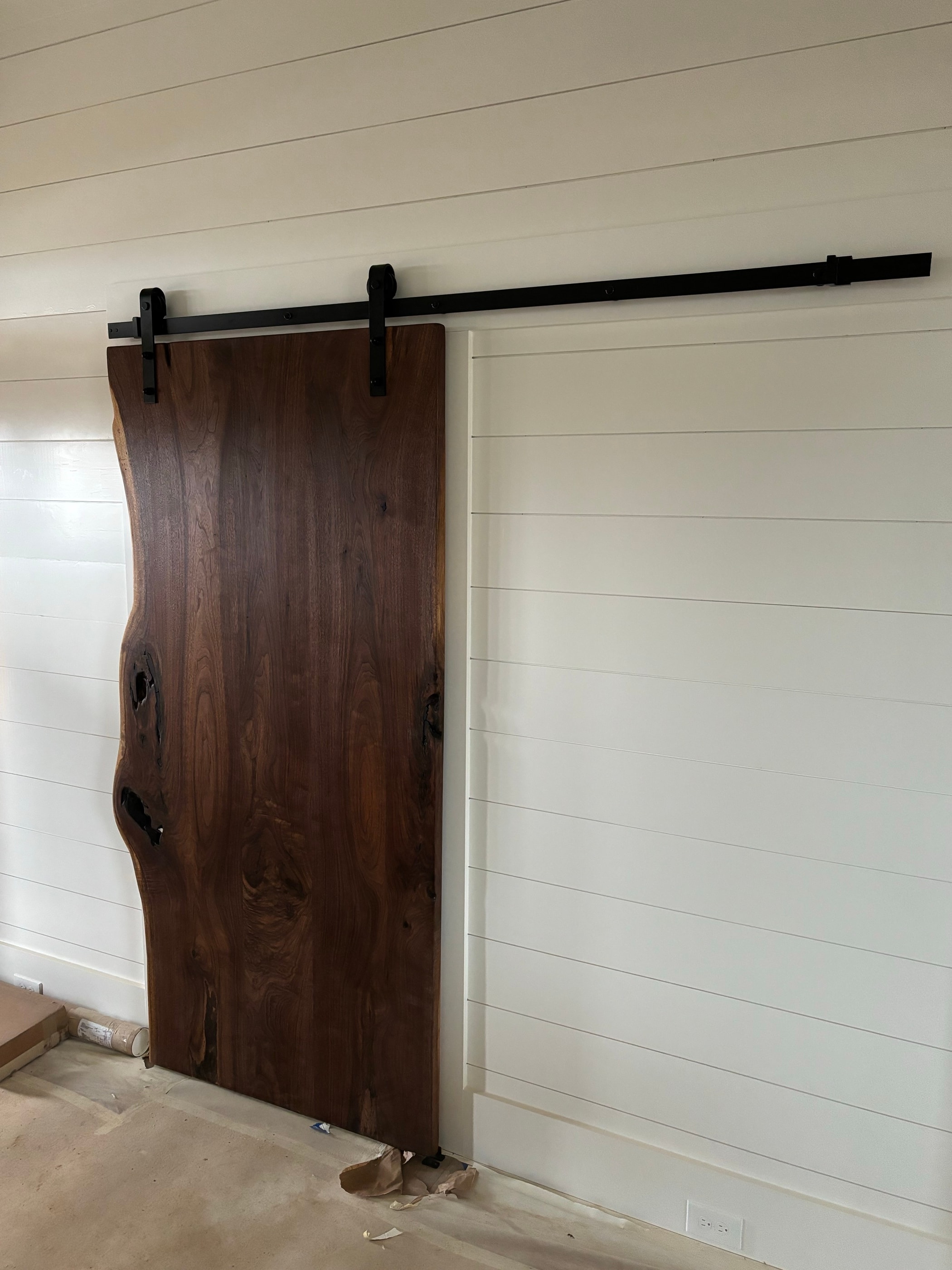 Live-edge wood barn door on a sliding track