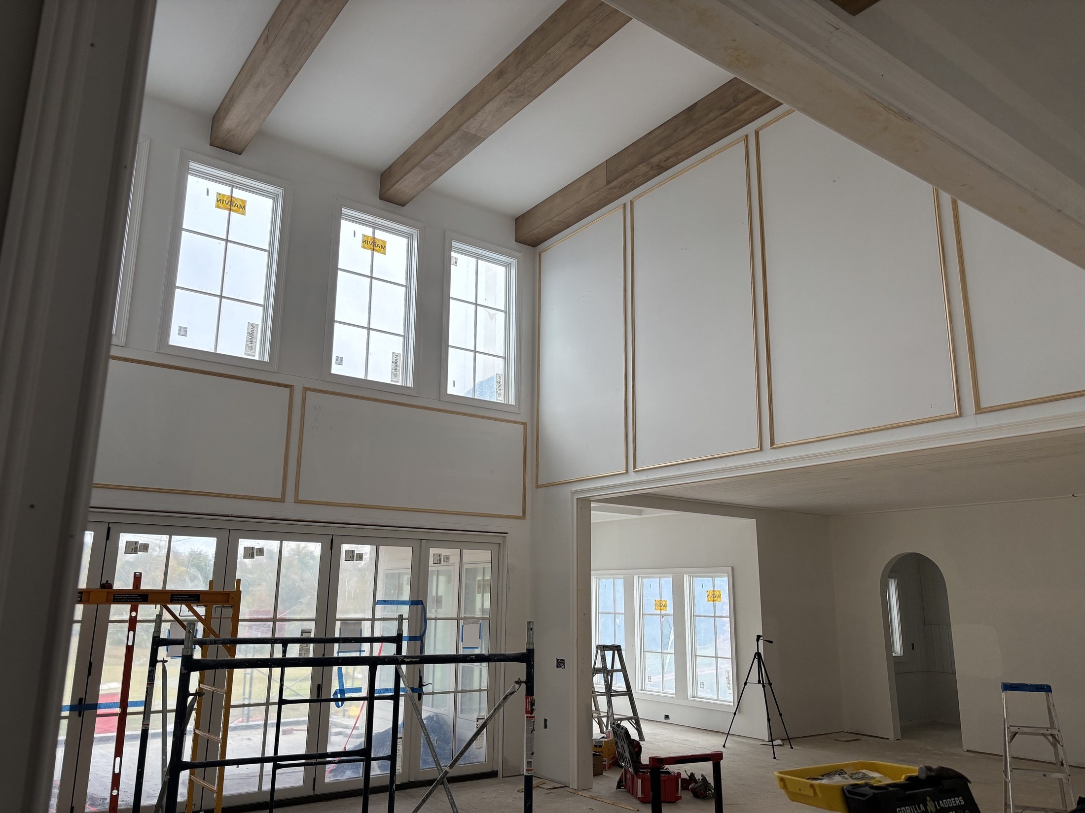 Tall picture-frame wainscoting in a two-story great room