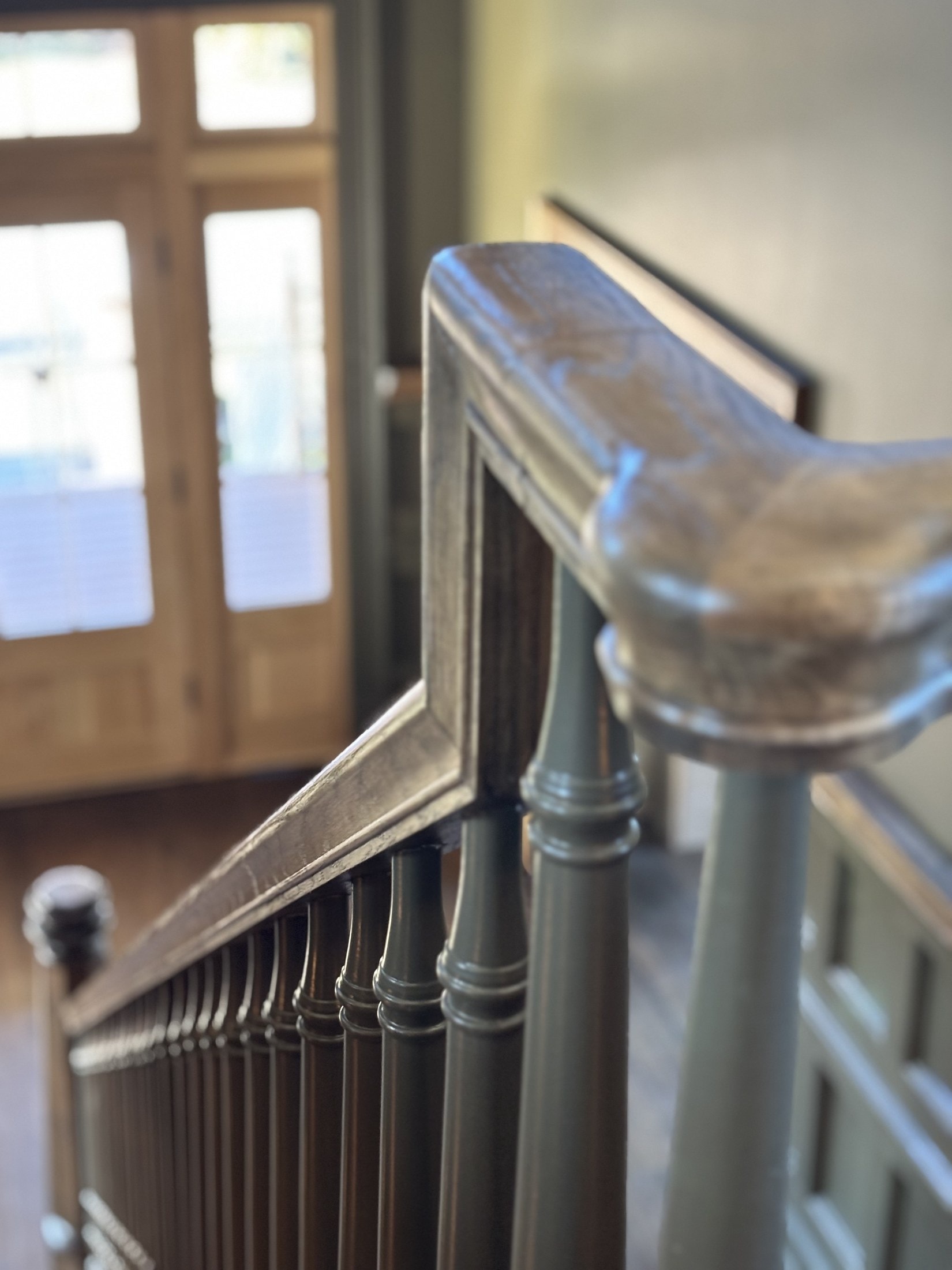 Over-the-post handrail and newel detail on a finished staircase