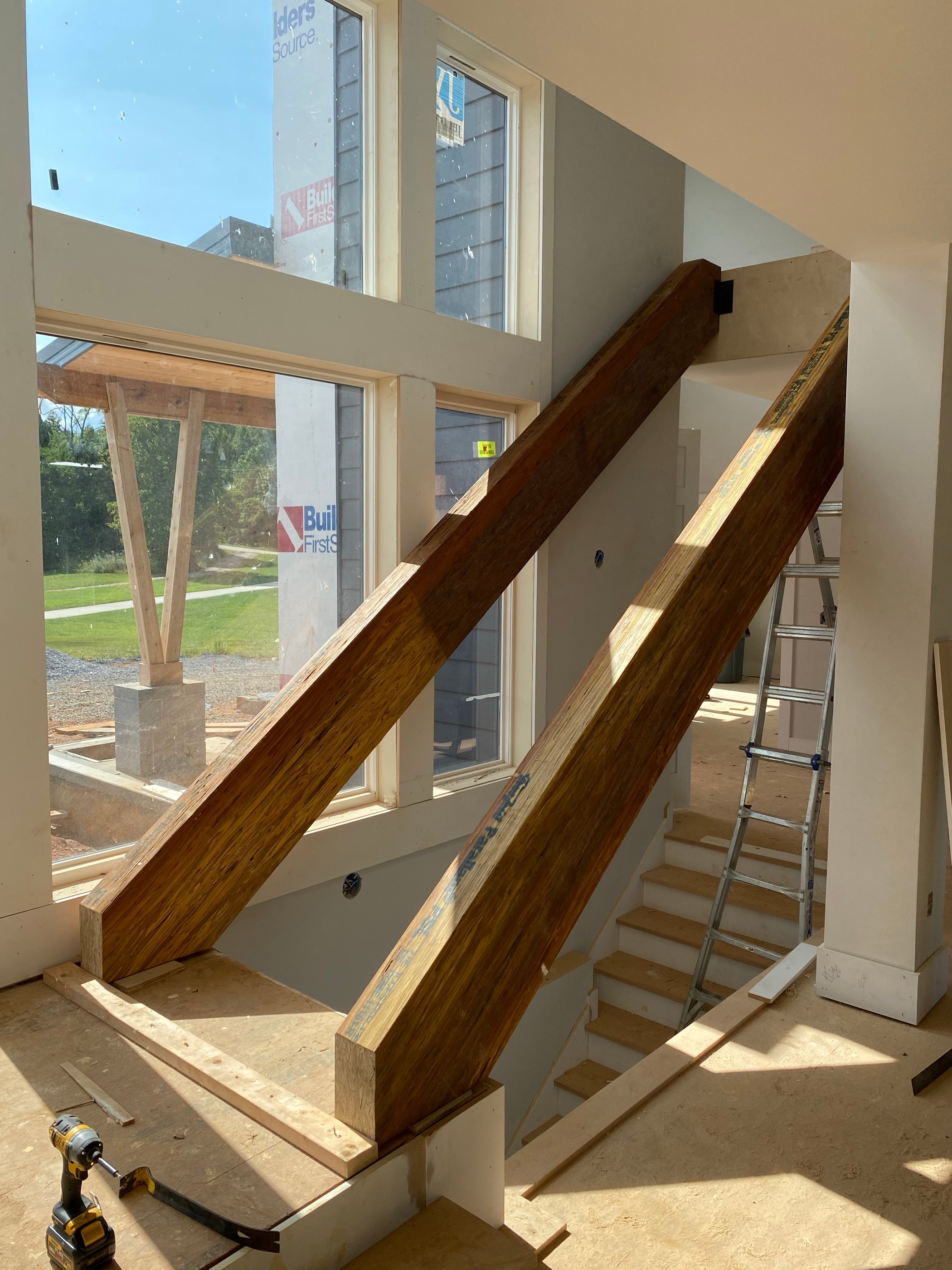 Modern staircase with wood treads and a glass-and-metal railing