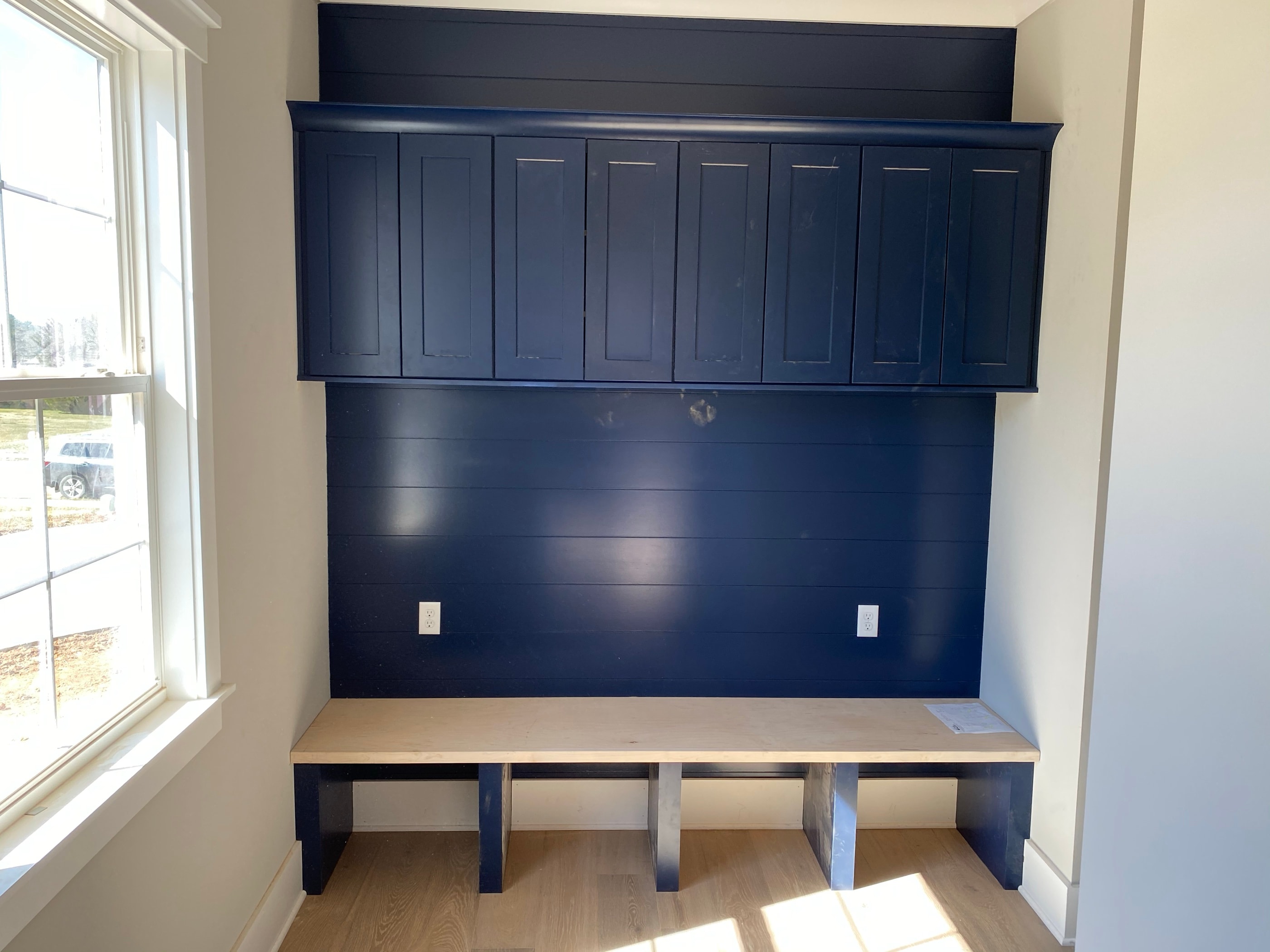 Navy-blue mudroom lockers with a bench and cubbies