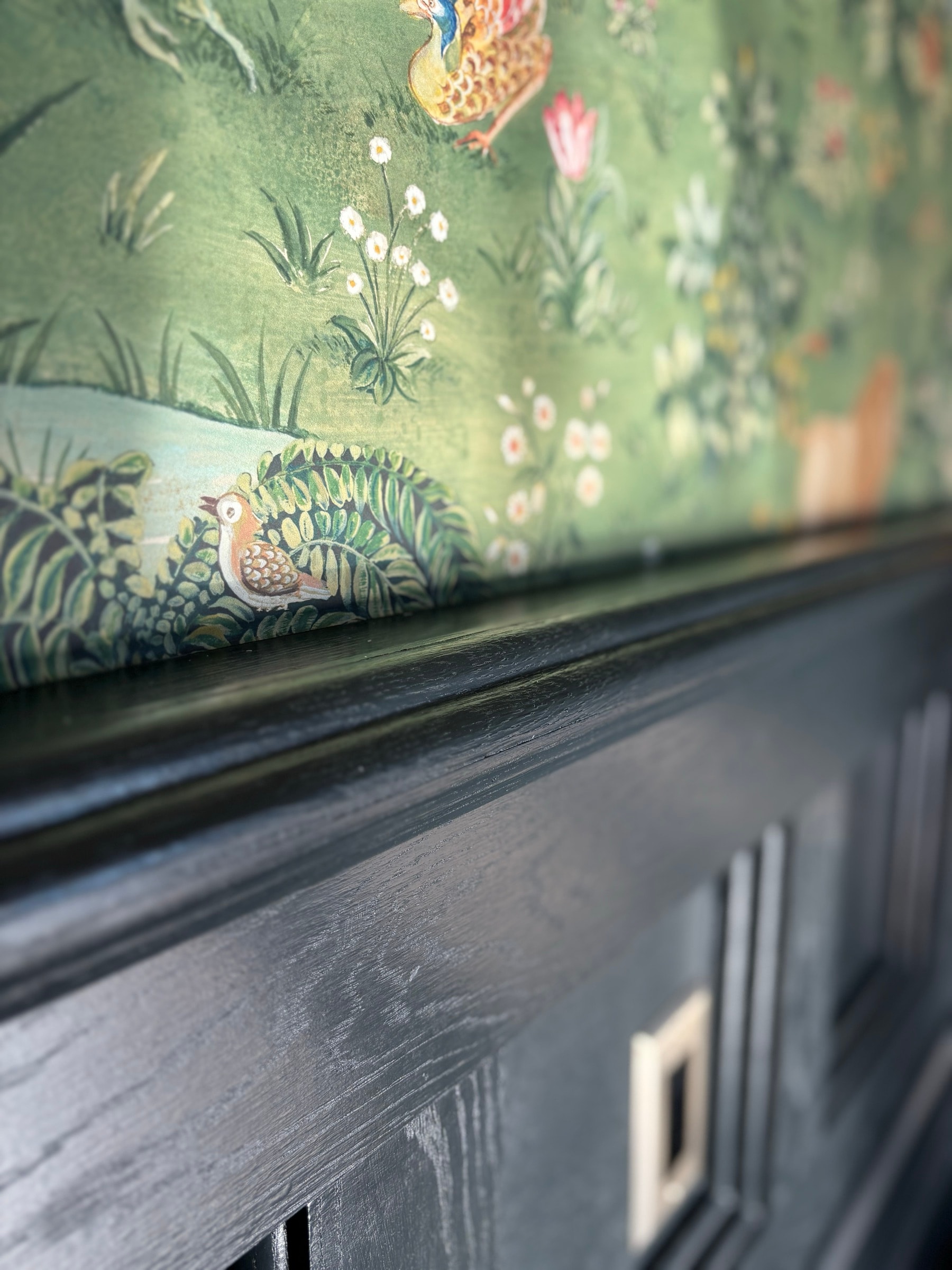 Trim and wainscot detailing framing a mural feature wall