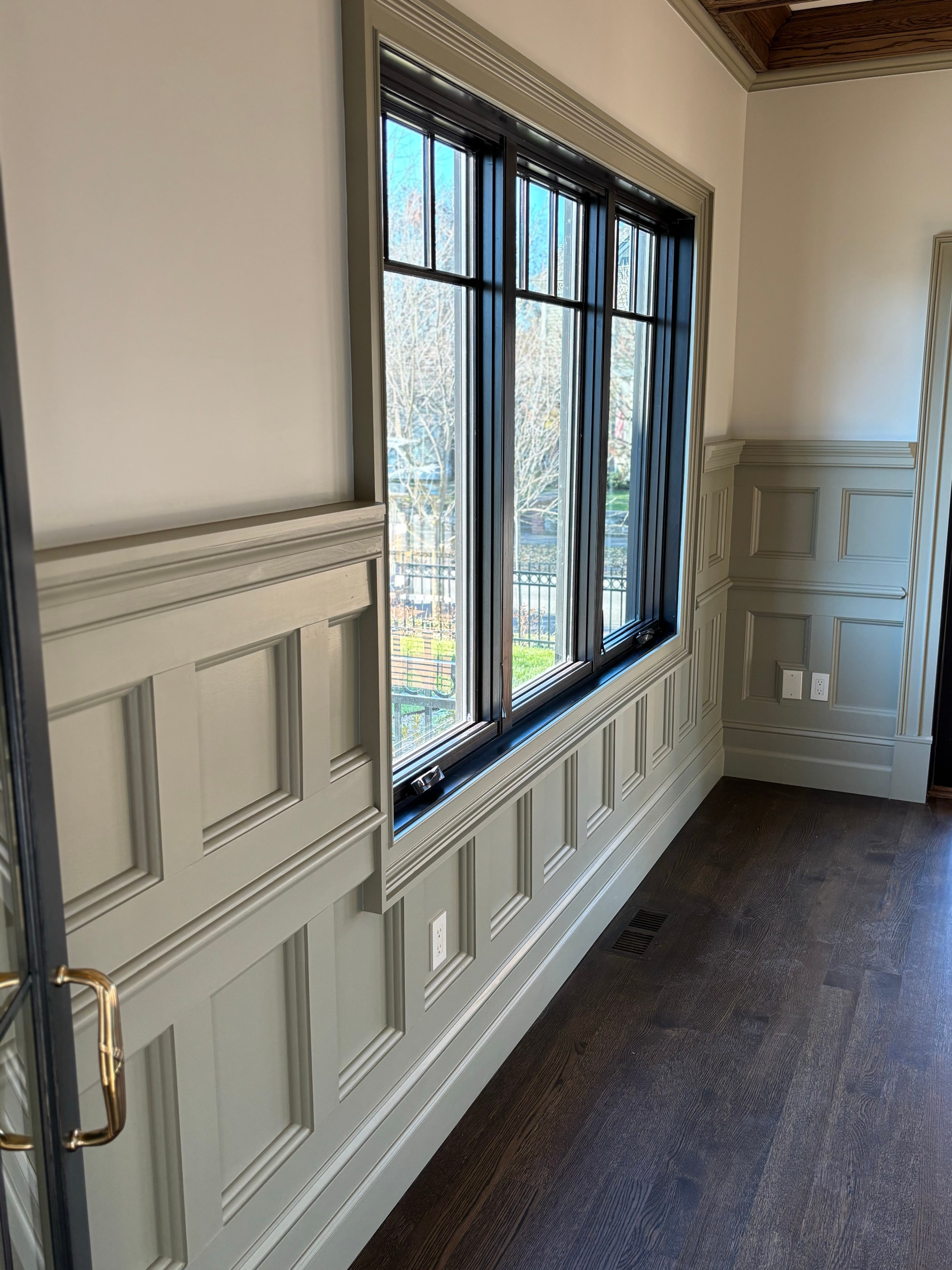 Bedroom with picture-frame wainscoting between the windows