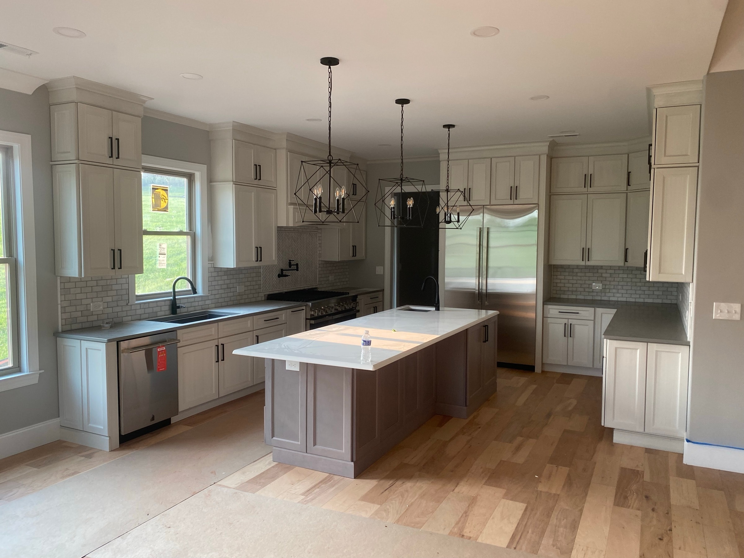 White kitchen cabinetry with a large island, set and detailed
