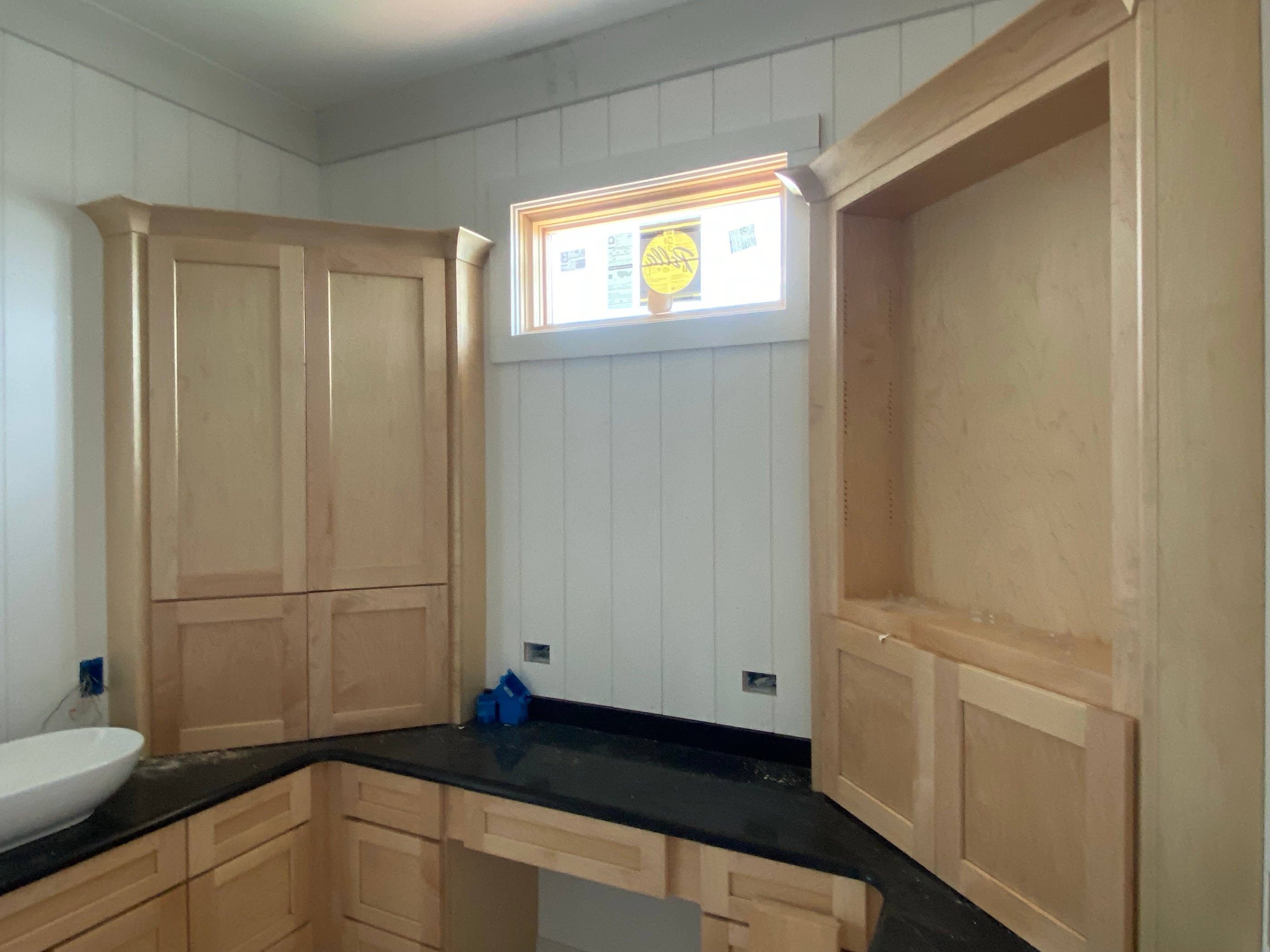 Wood-paneled room with a cased opening and stain-grade trim